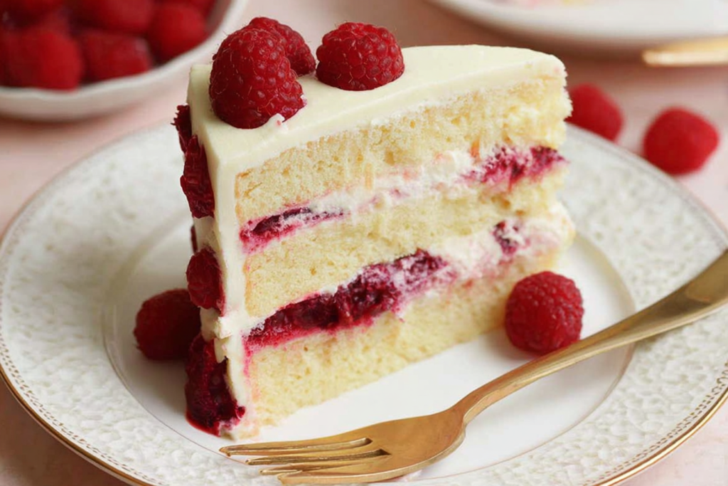 Close up of White Chocolate Raspberry Dream Cake soft layers and raspberry center